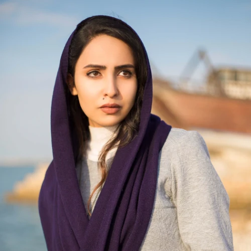 fashion-model-seaside-covering-her-head-with-black-shawl-sitting-stones (1) (1)